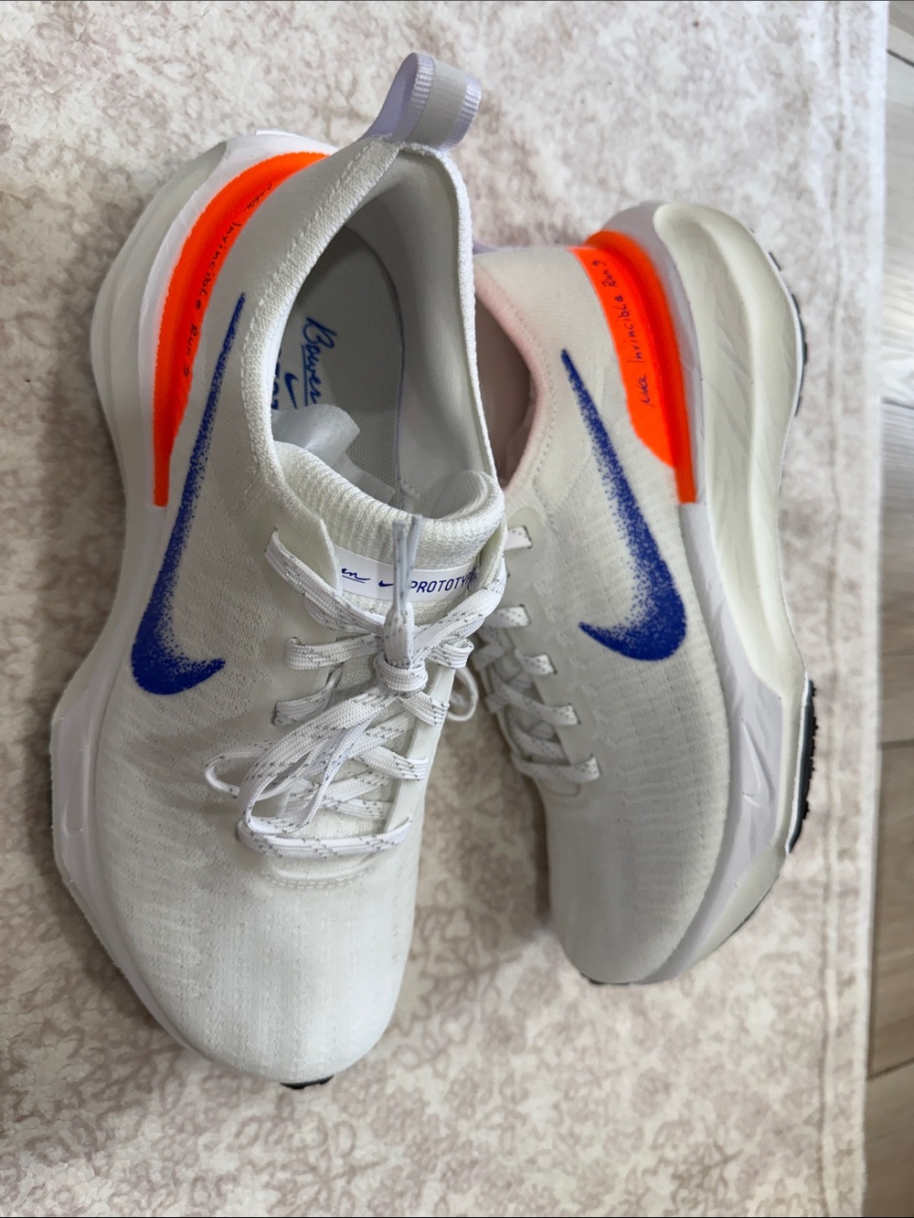 Nike White Running Shoes with Blue Swoosh and Neon Orange Heel